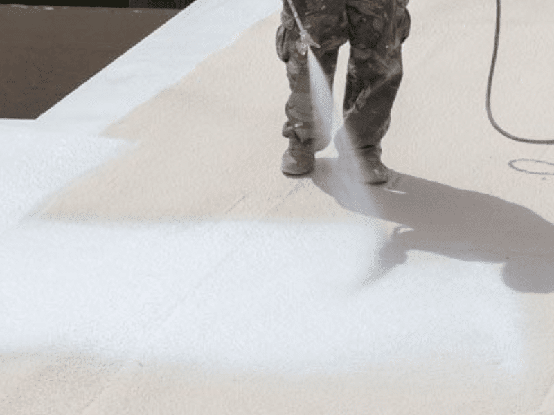 Spraying a roof coating on a commercial roof in phoenix az