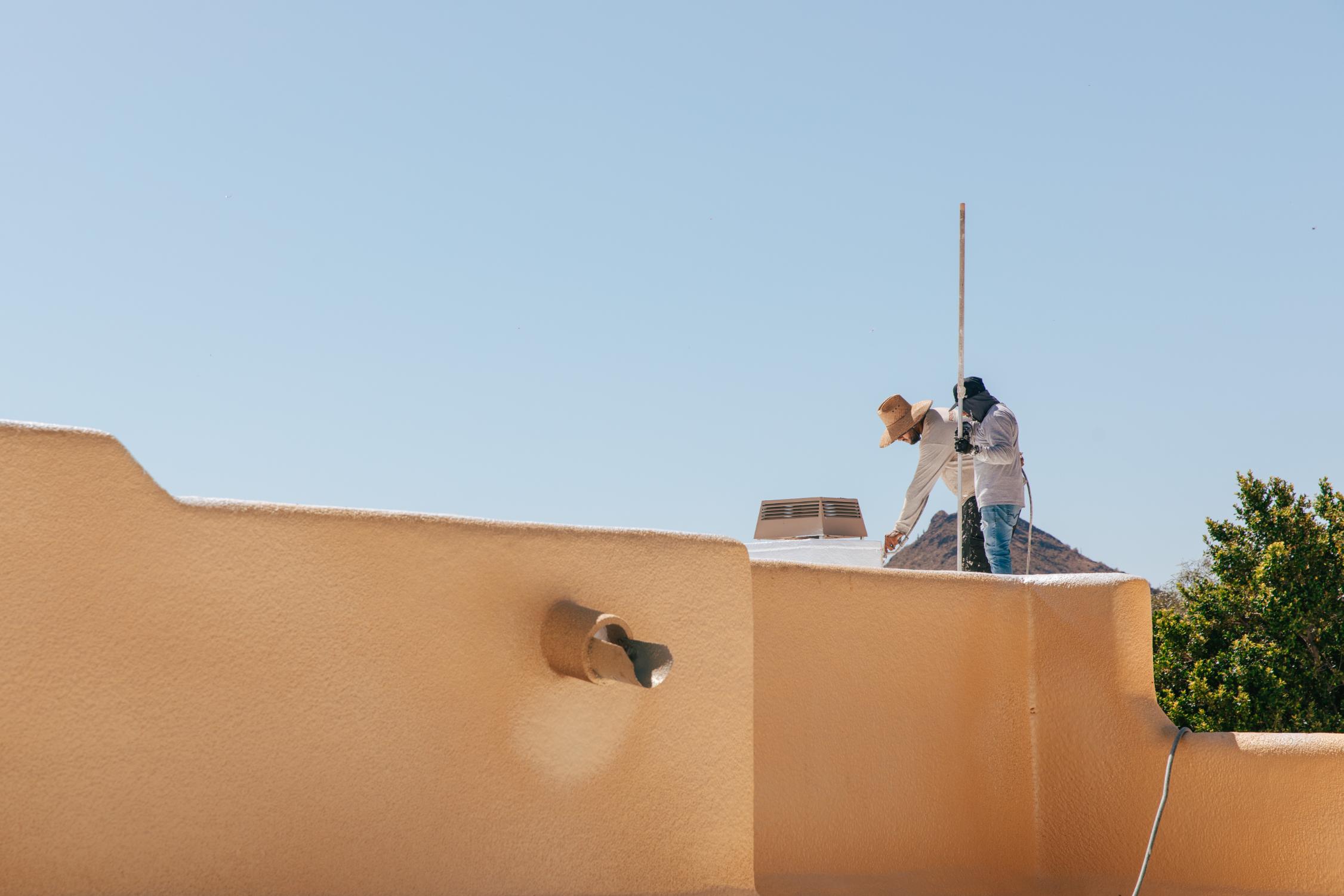 RENCO roofers working on flat roof home