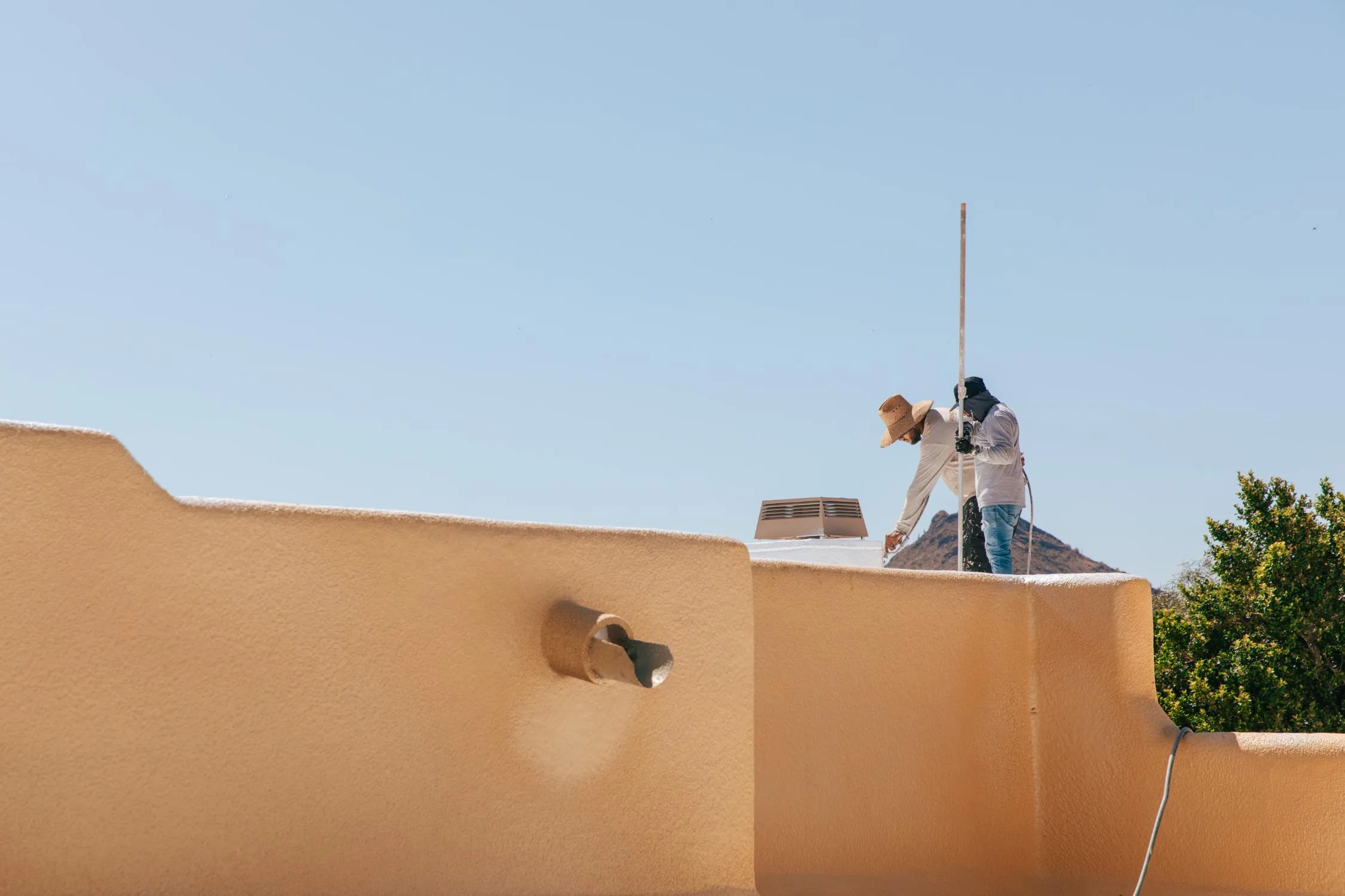 RENCO roofers working on flat roof home