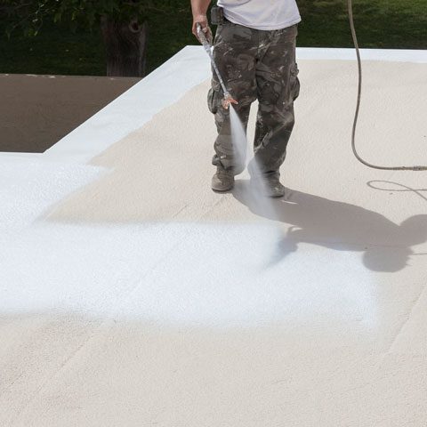 roof-coatings Paint roller applying white roof covering