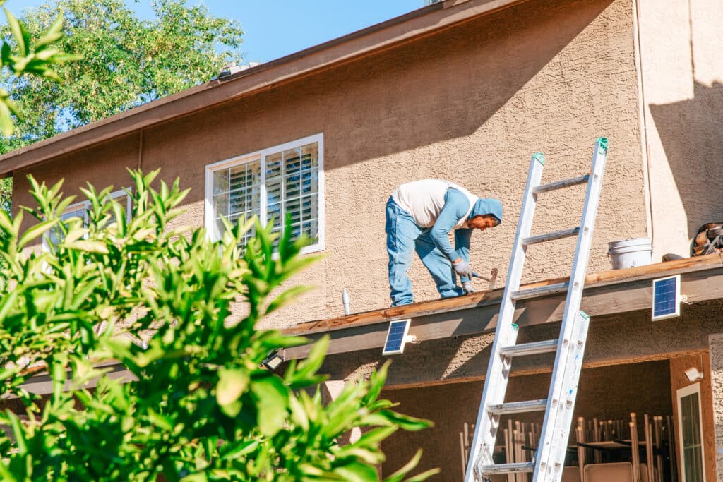 Roofer working on patio roof in Arizona