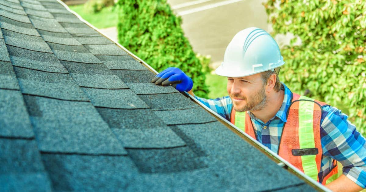 Inspector looking at roof for signs of damage
