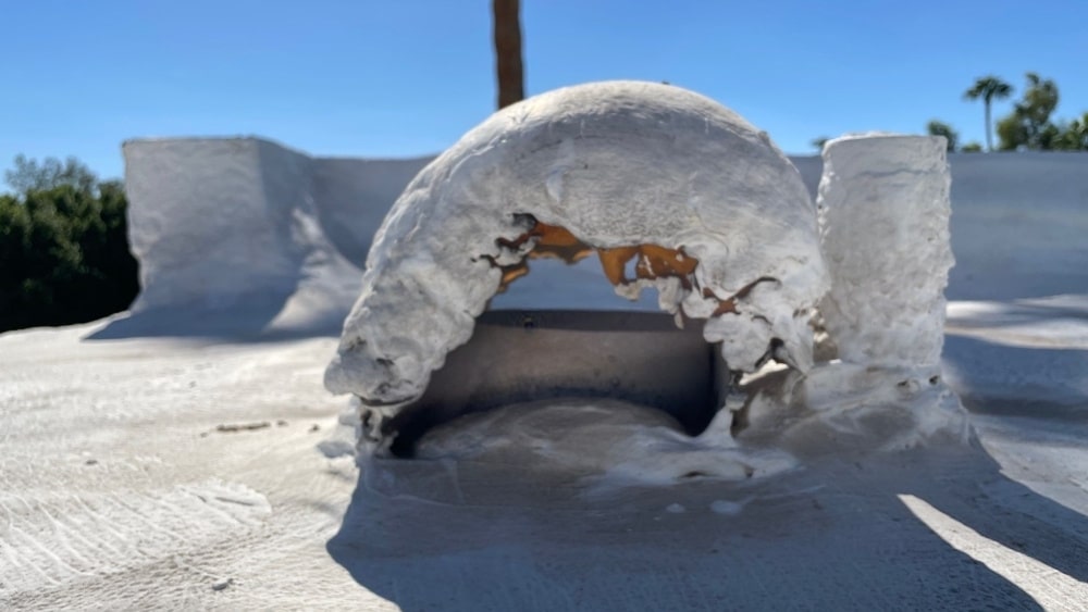 Deteriorating flashing around roof penetration on Phoenix foam roof needing repair