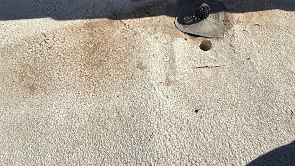 Visible cracks in foam roof surface in Phoenix showing early signs of foam roof repair needs