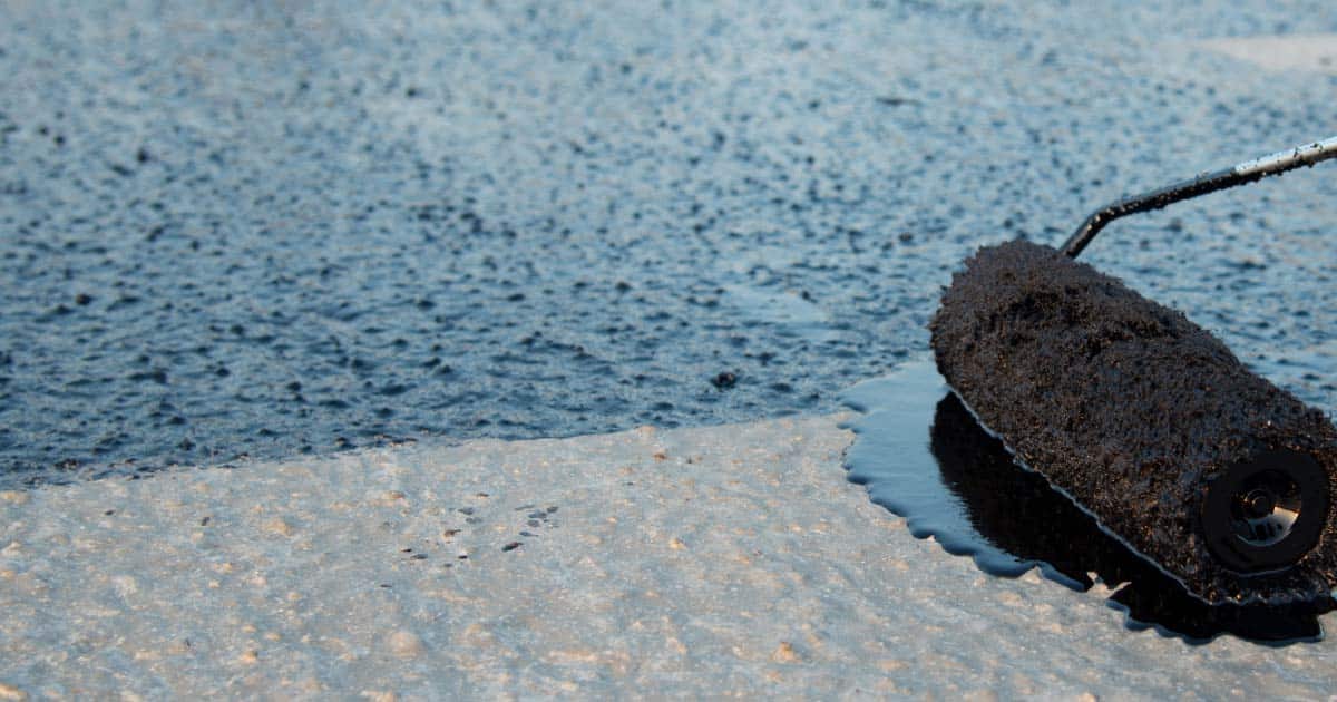 Chandler roof being recoated with roller