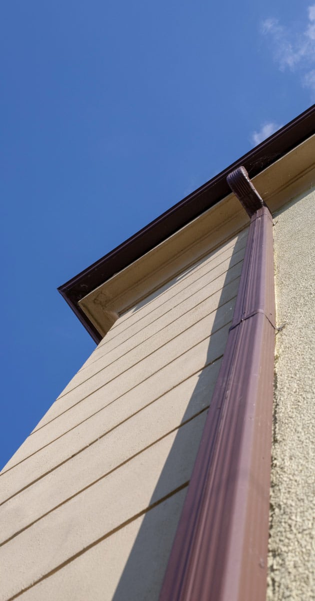 Photo of gutters attached to two story building